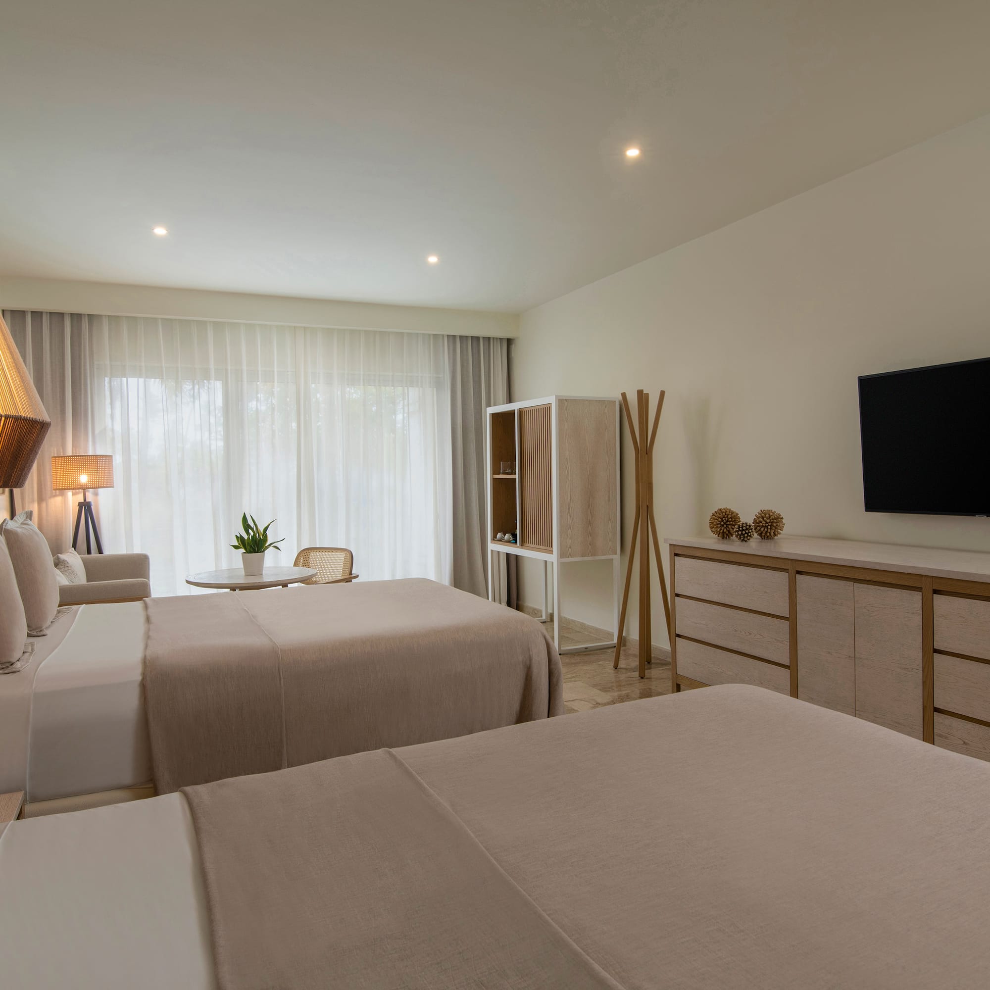 a room with two beds and a tv