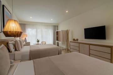 a room with two beds and a tv