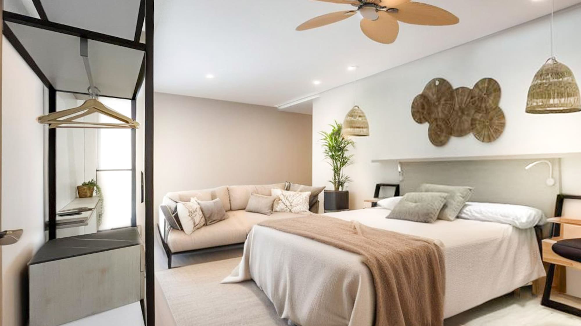 a bedroom with a large bed and a couch