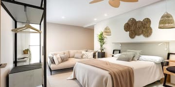 a bedroom with a large bed and a couch