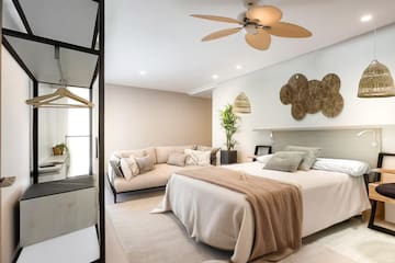 a bedroom with a large bed and a couch