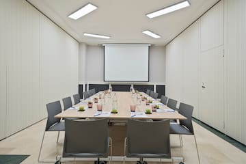 a conference room with a table and chairs