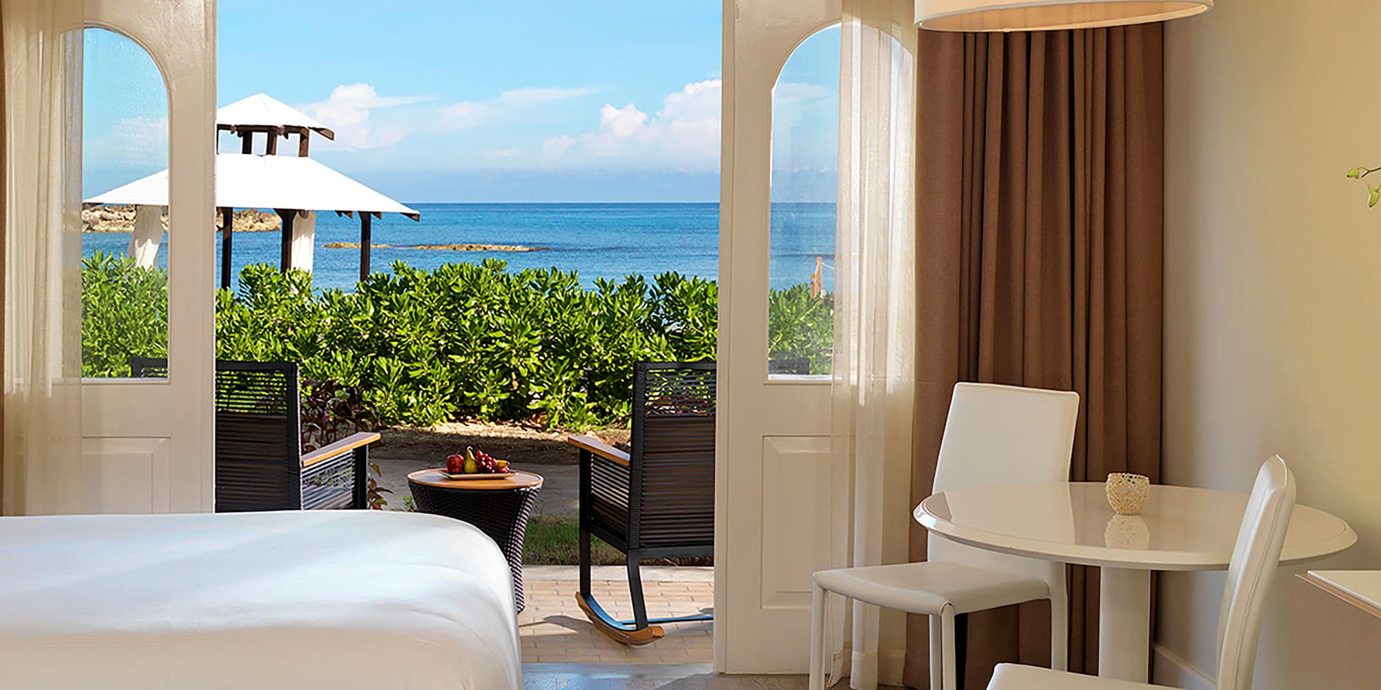 a room with a bed and table and chairs