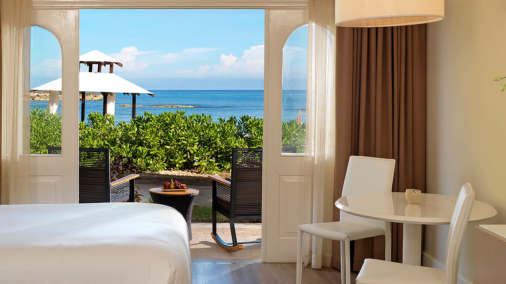 a room with a bed and table and chairs