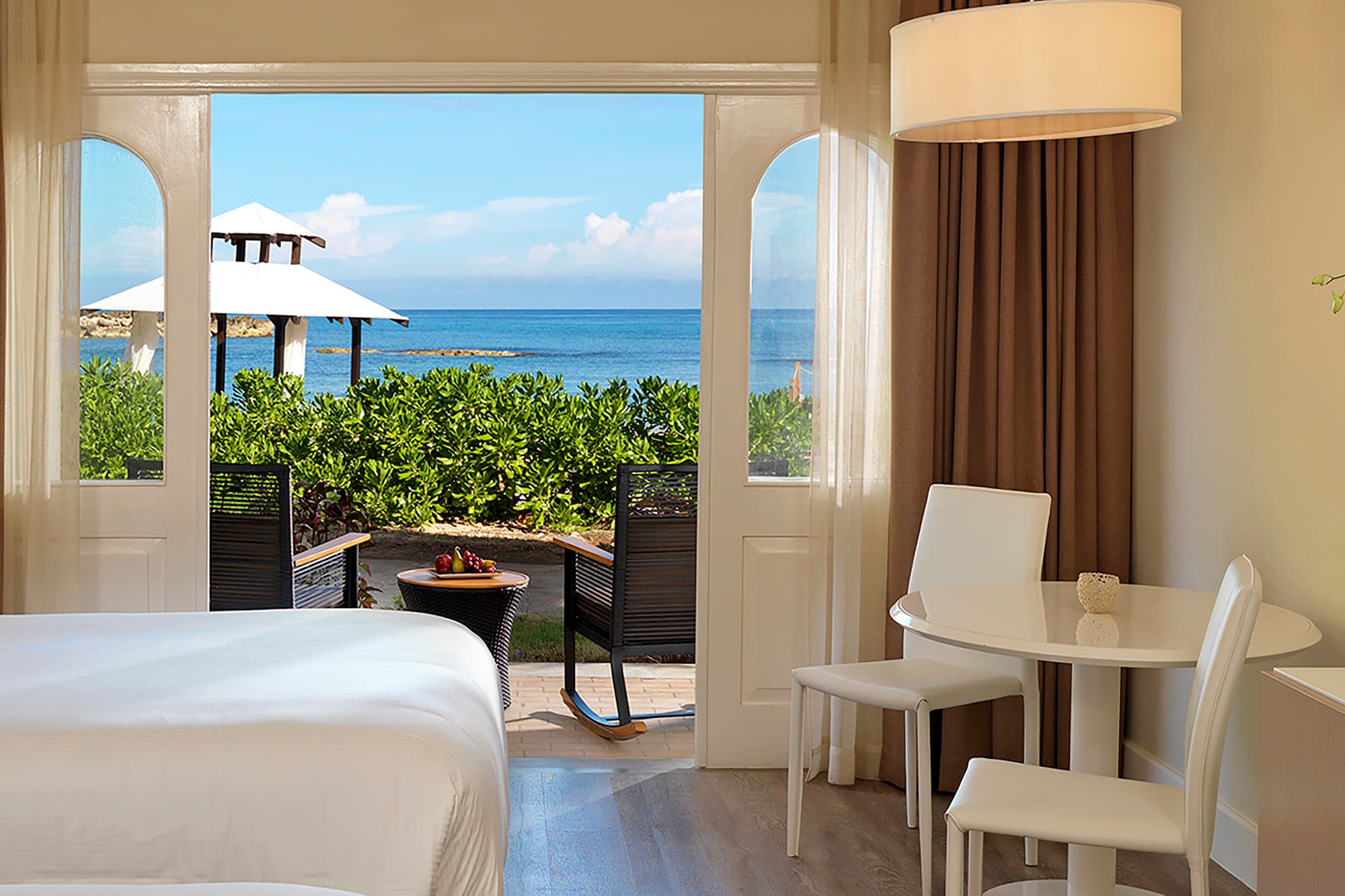 a room with a bed and table and chairs