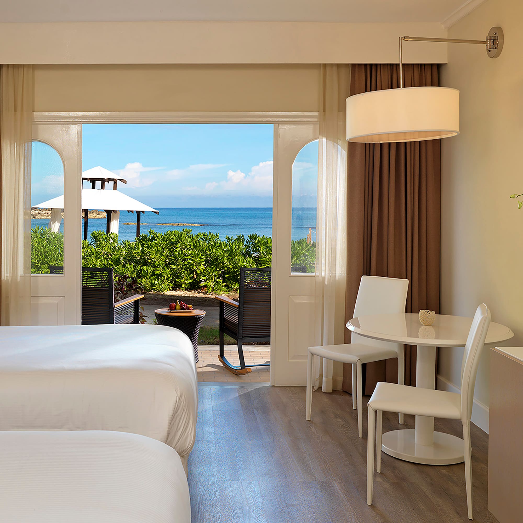 a room with a bed and table and chairs