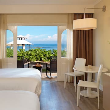 a room with a bed and table and chairs