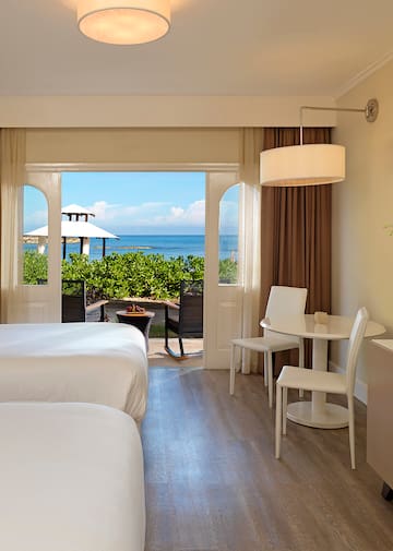 a room with a bed and table and chairs