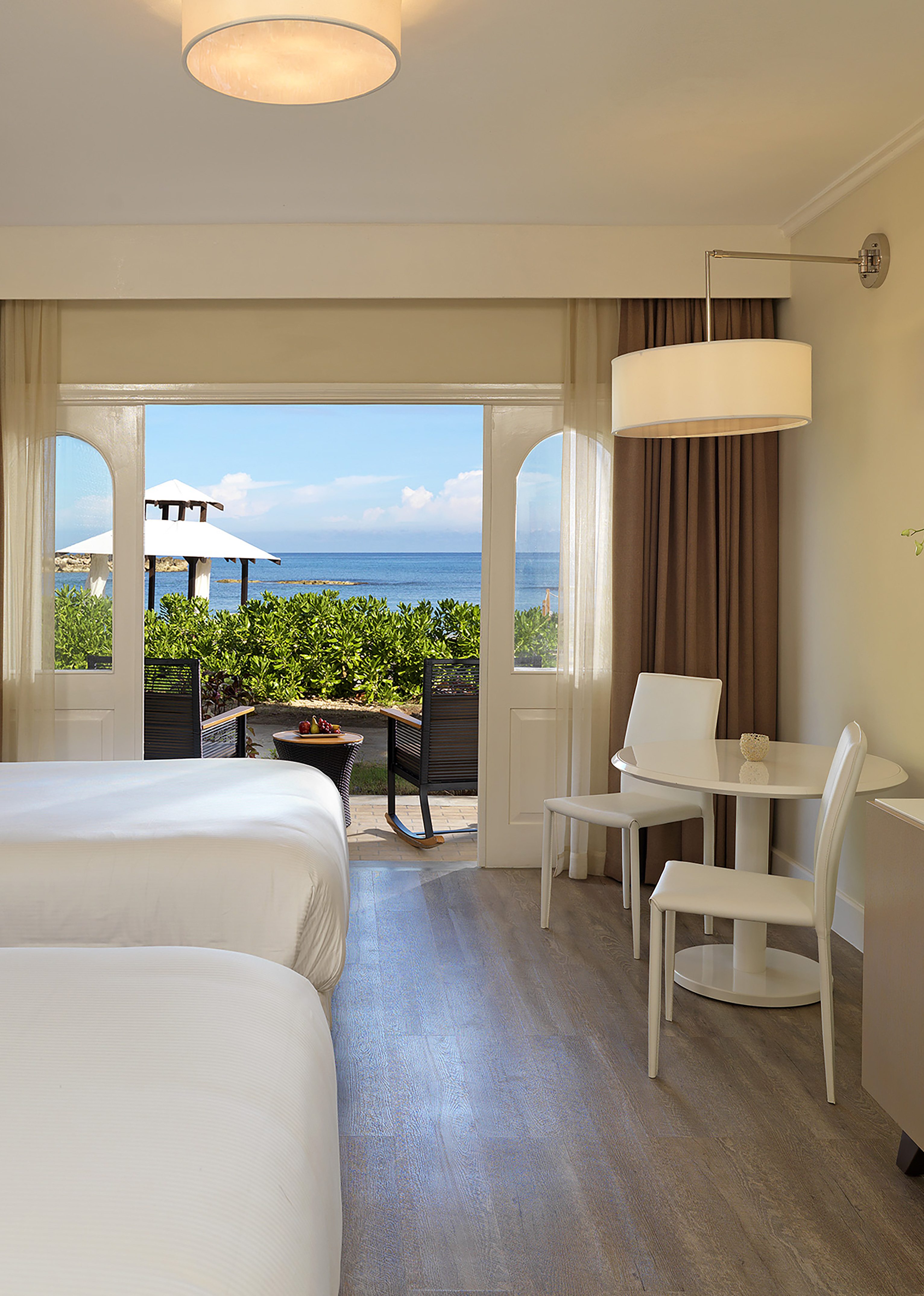 a room with a bed and table and chairs