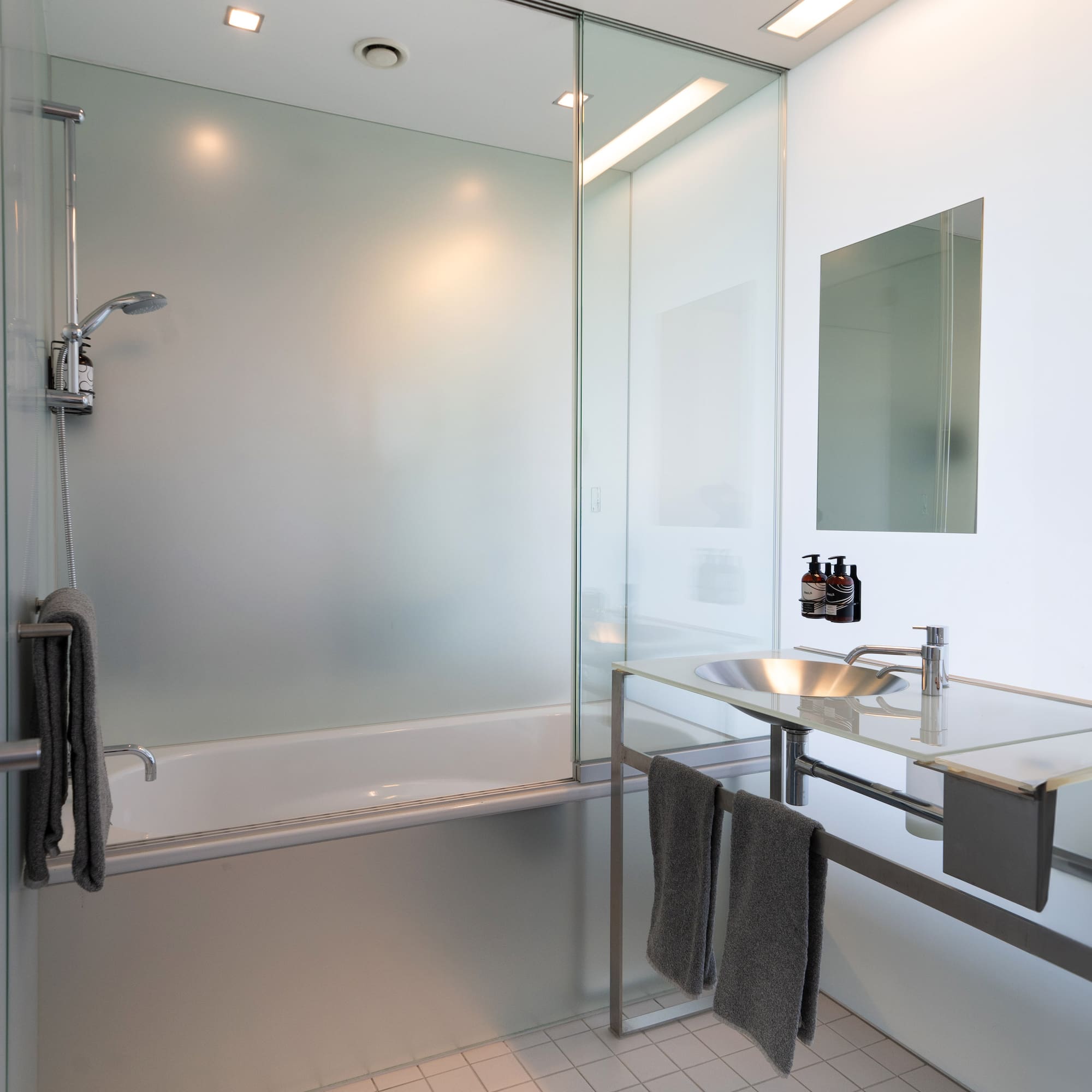 a bathroom with a glass shower and sink