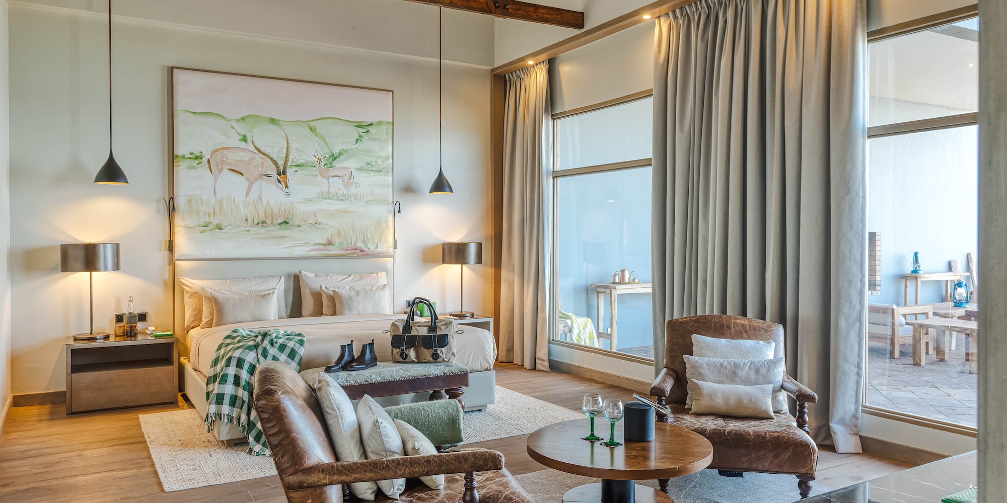 a room with a bed and chairs