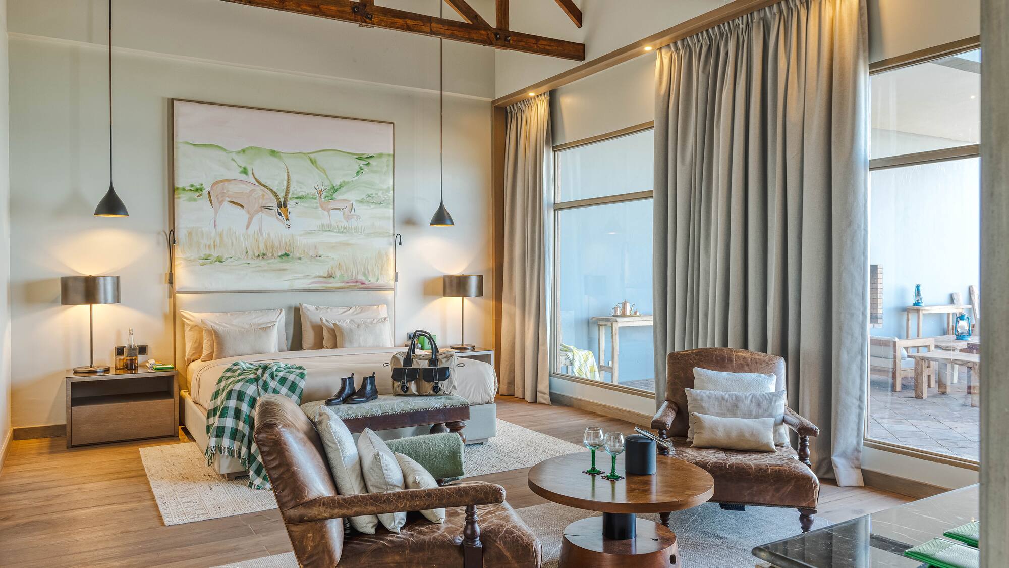 a room with a bed and chairs