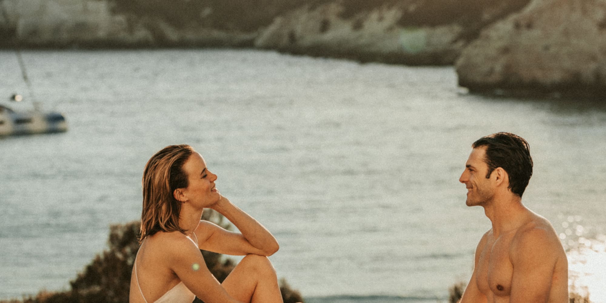 a man and woman sitting in a pool