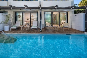 a pool with chairs and chairs on deck