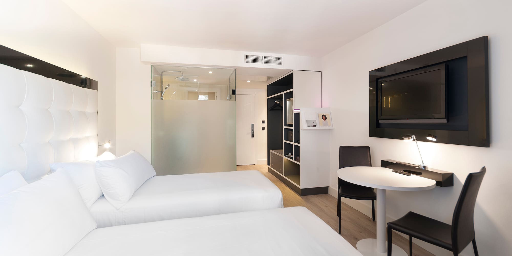 a room with two beds and a tv