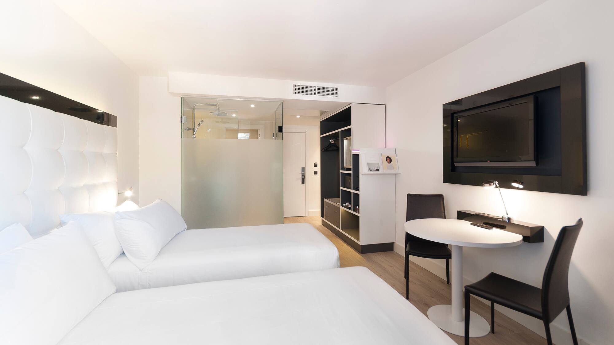 a room with two beds and a tv