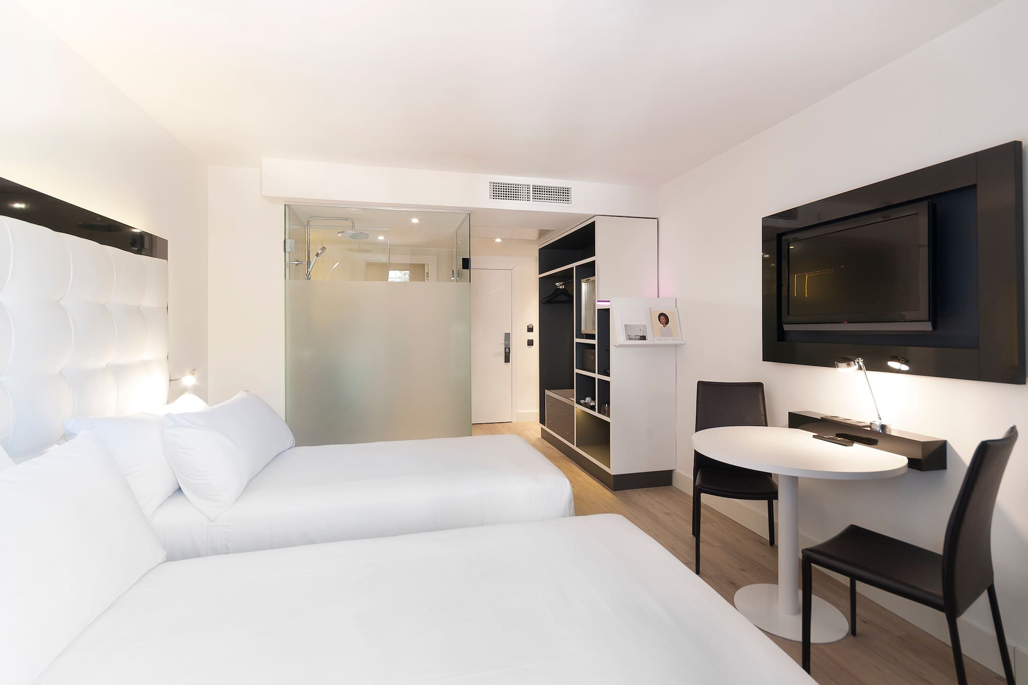 a room with two beds and a tv