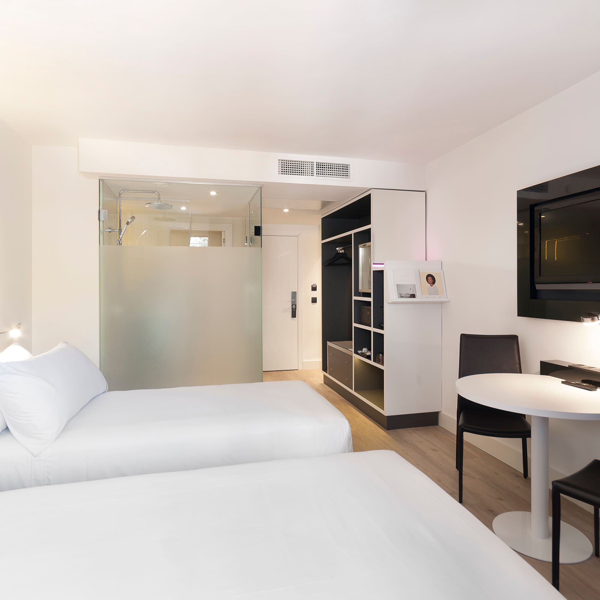 a room with two beds and a tv