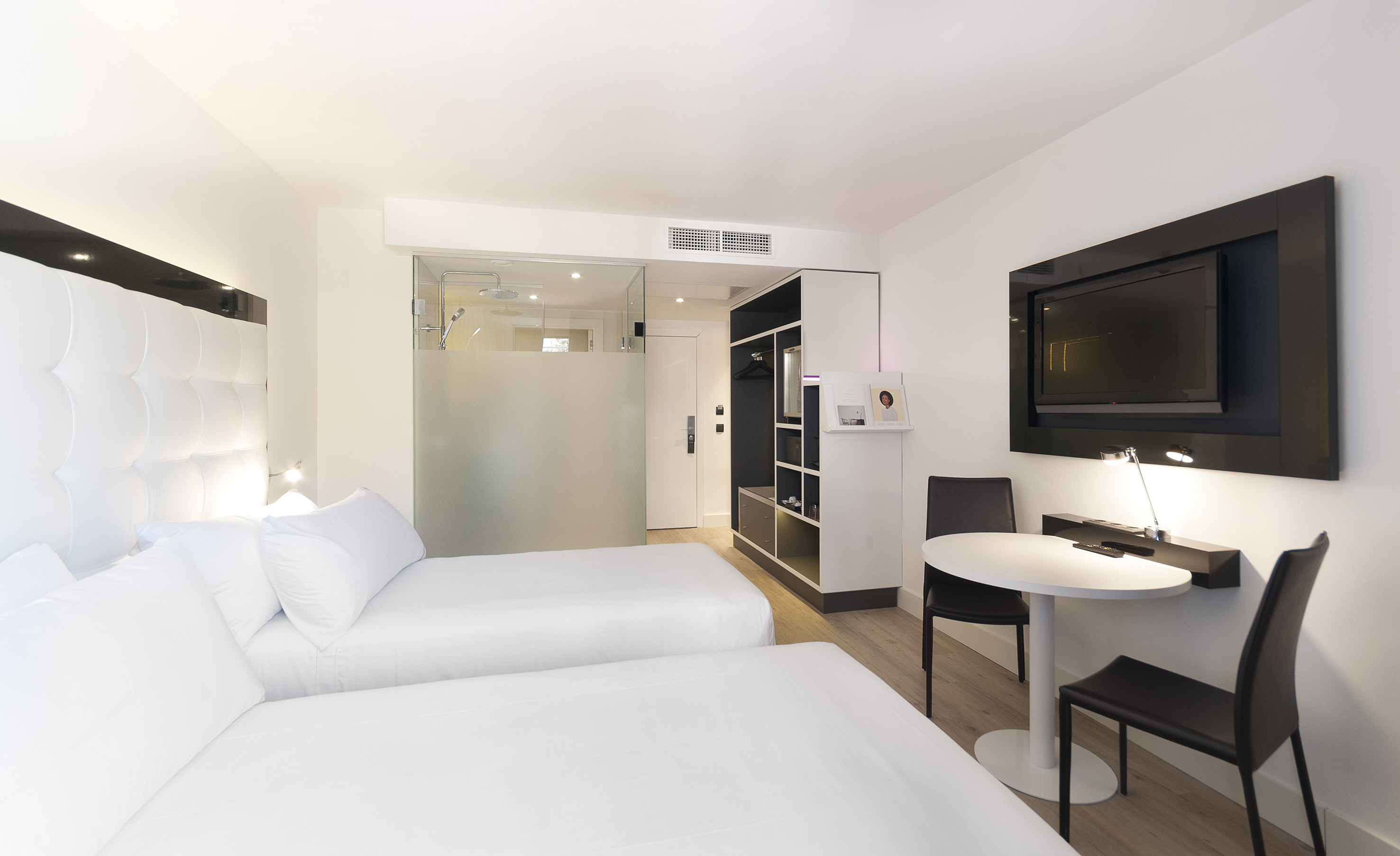 a room with two beds and a tv