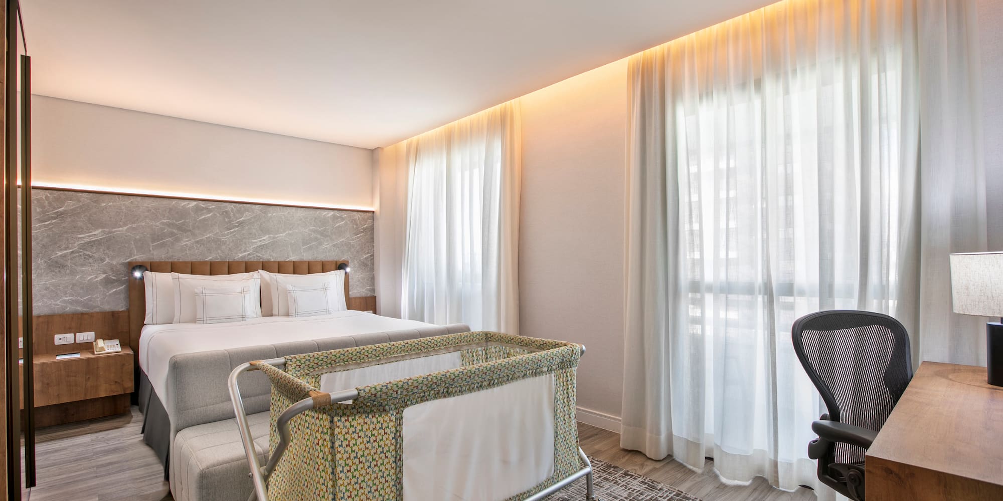 a room with a bed and a baby crib