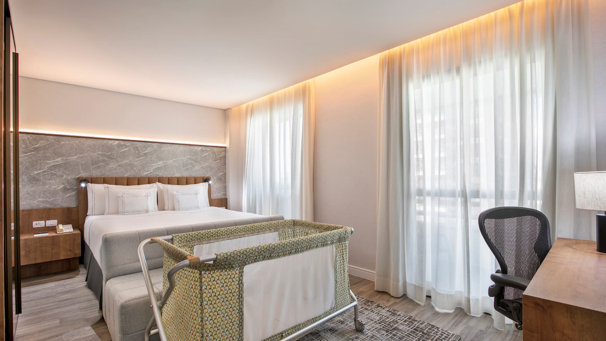 a room with a bed and a baby crib