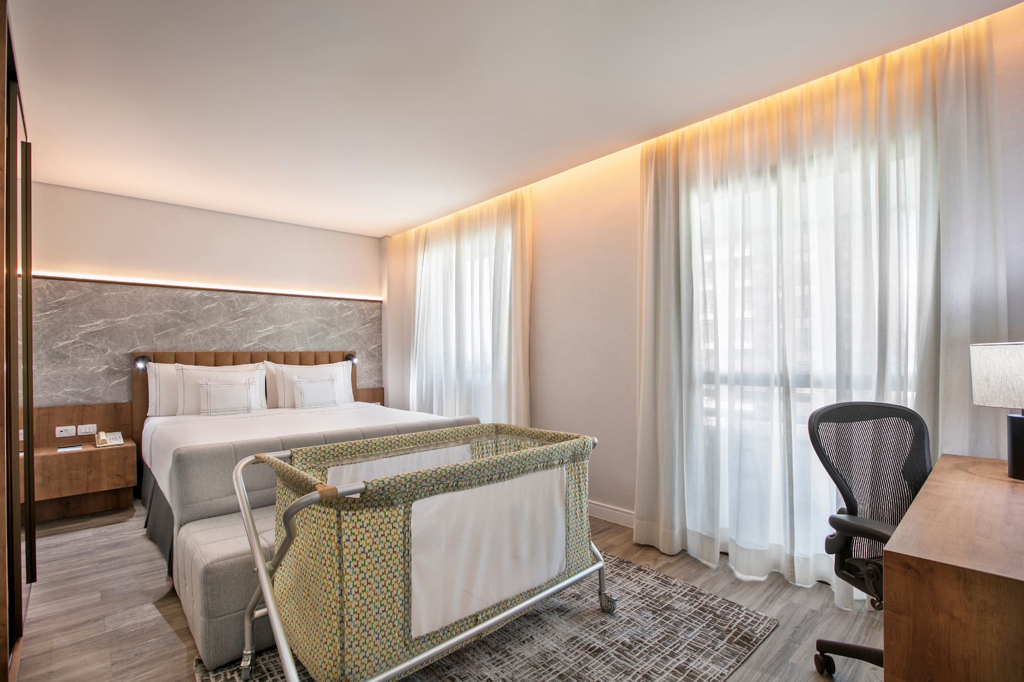 a room with a bed and a baby crib