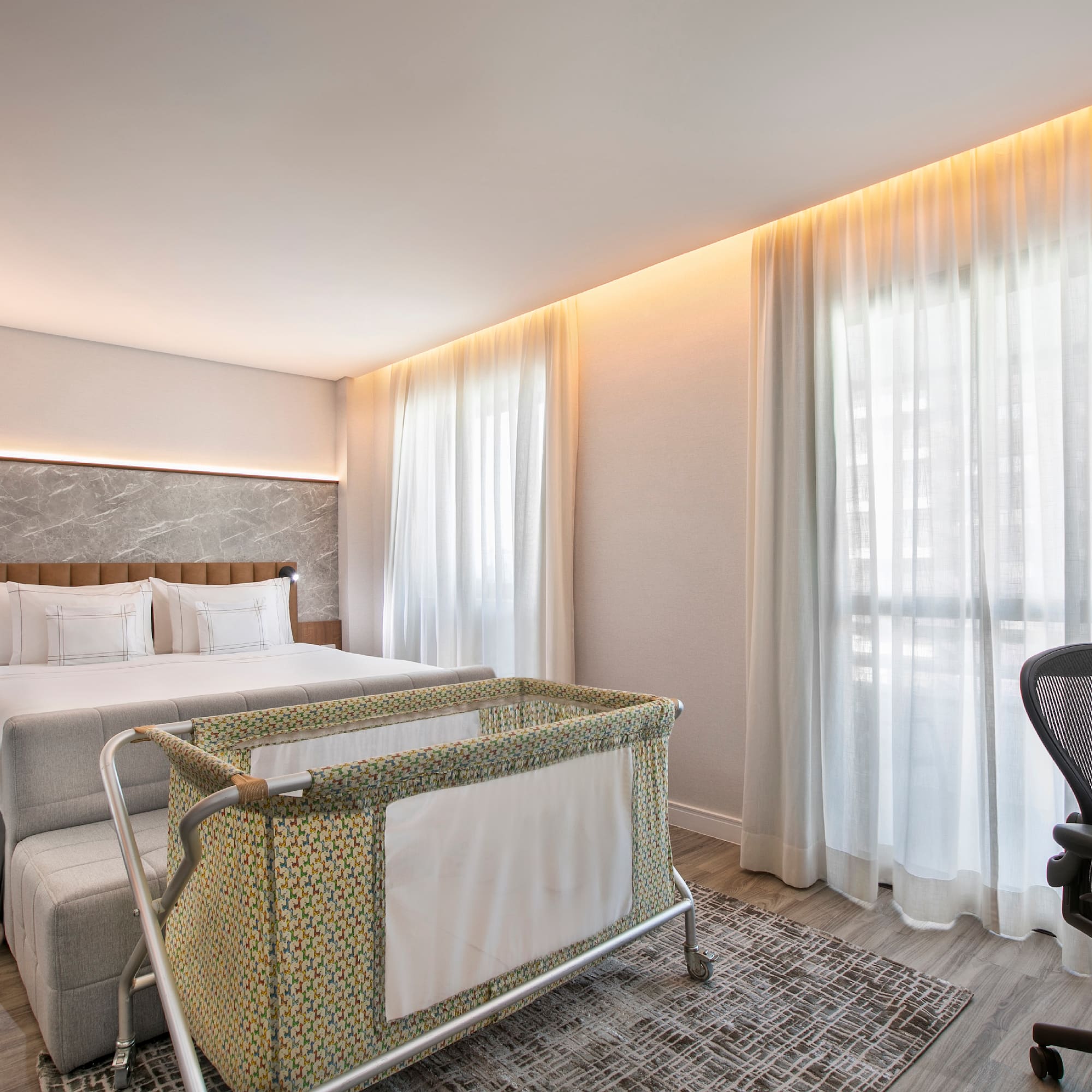 a room with a bed and a baby crib