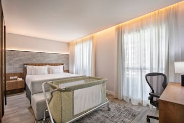 a room with a bed and a baby crib