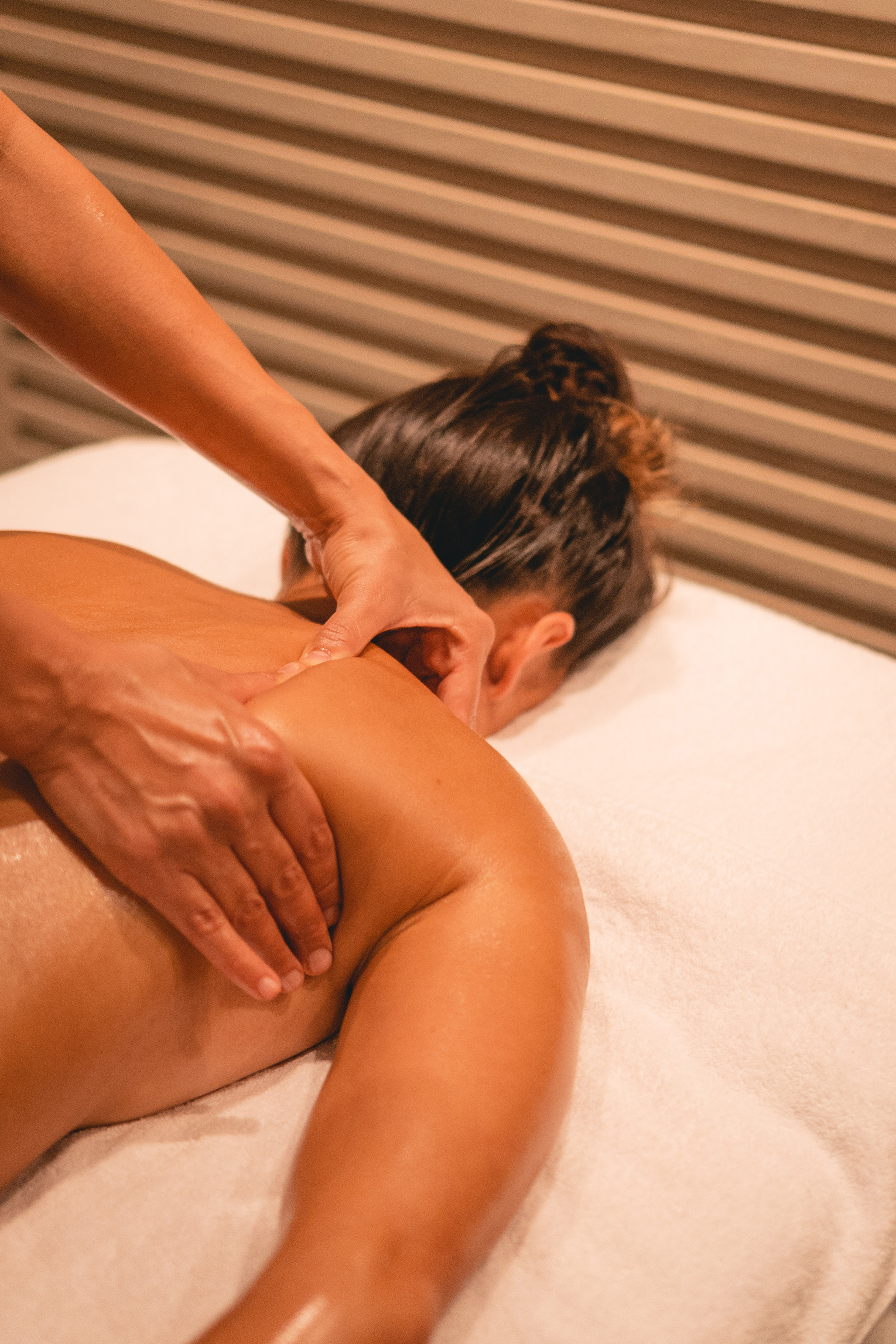 Therapeutic back and shoulder massage in a spa setting.