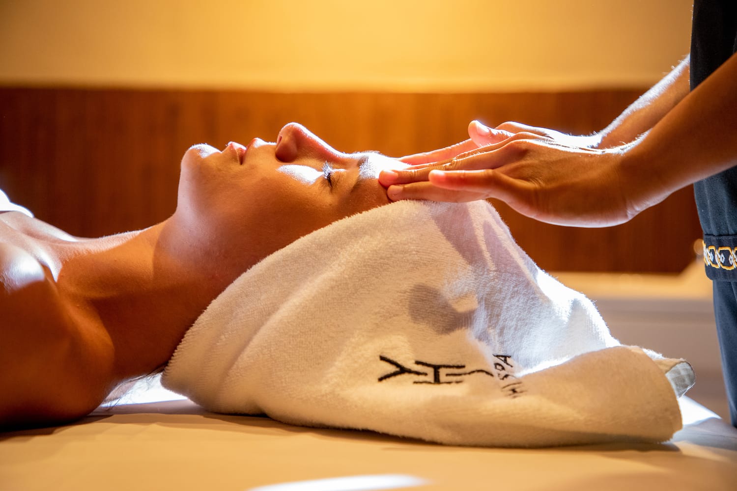 a person lying down with a towel on their head