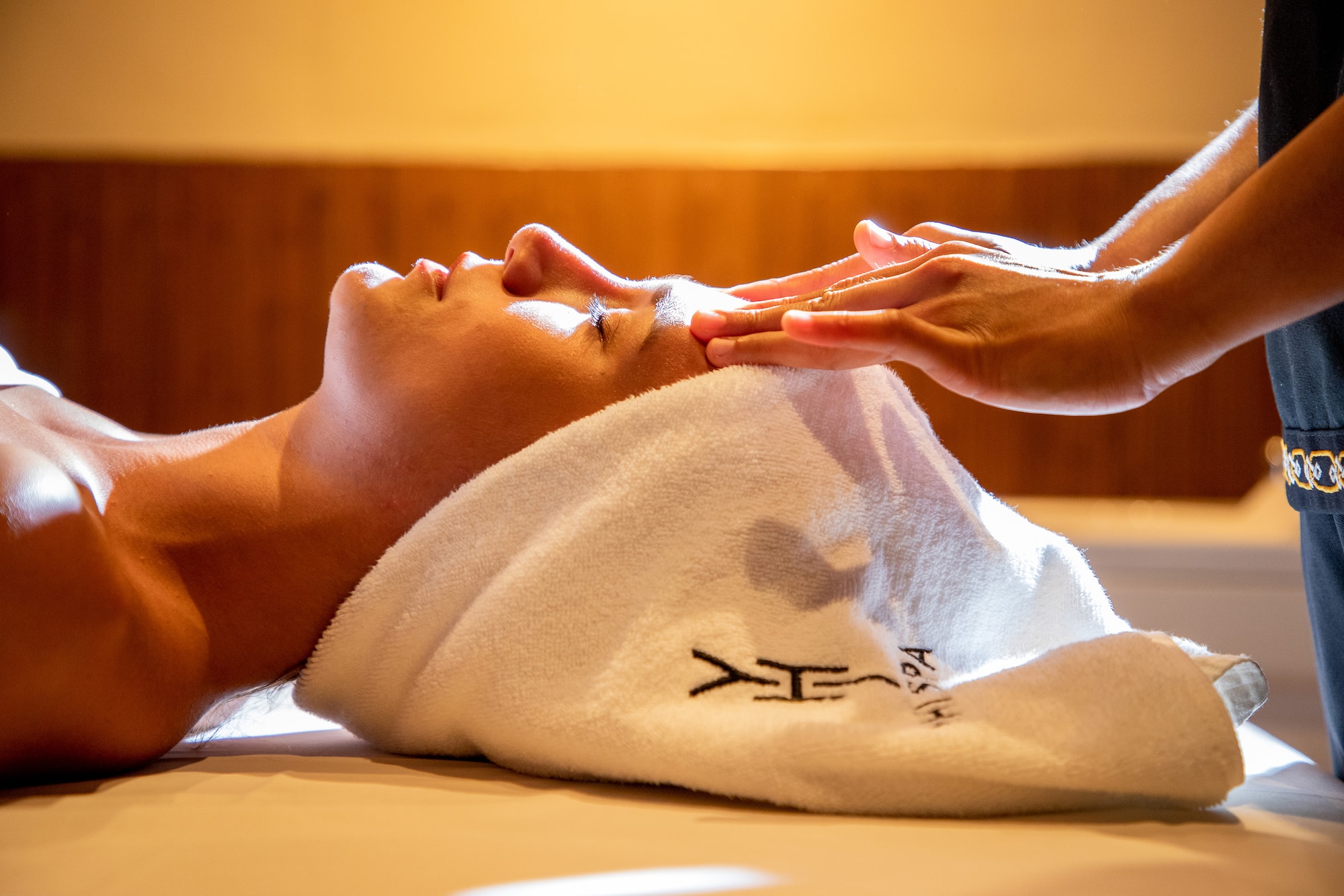 a person lying down with a towel on their head