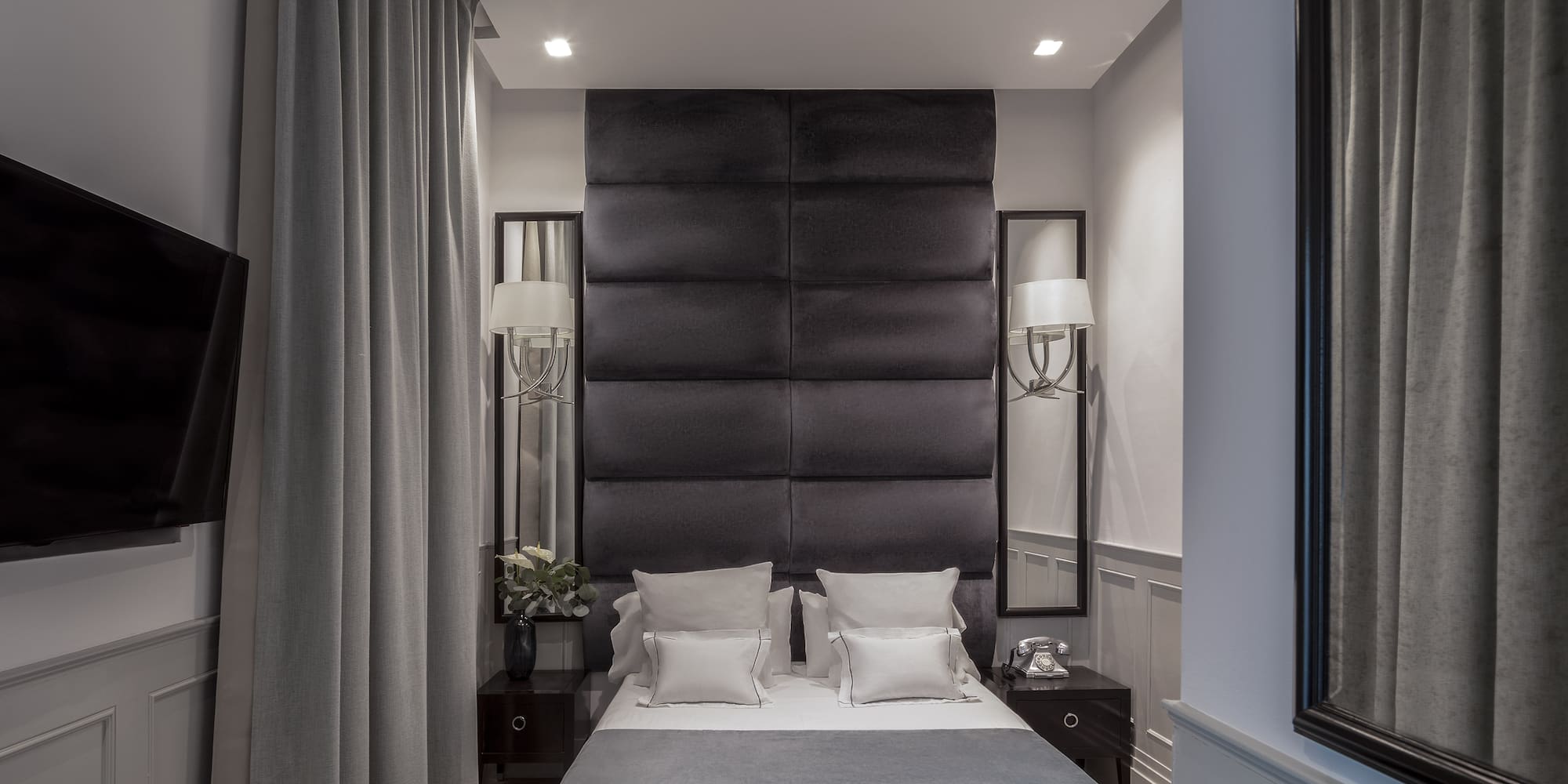 a bed with pillows and a black headboard
