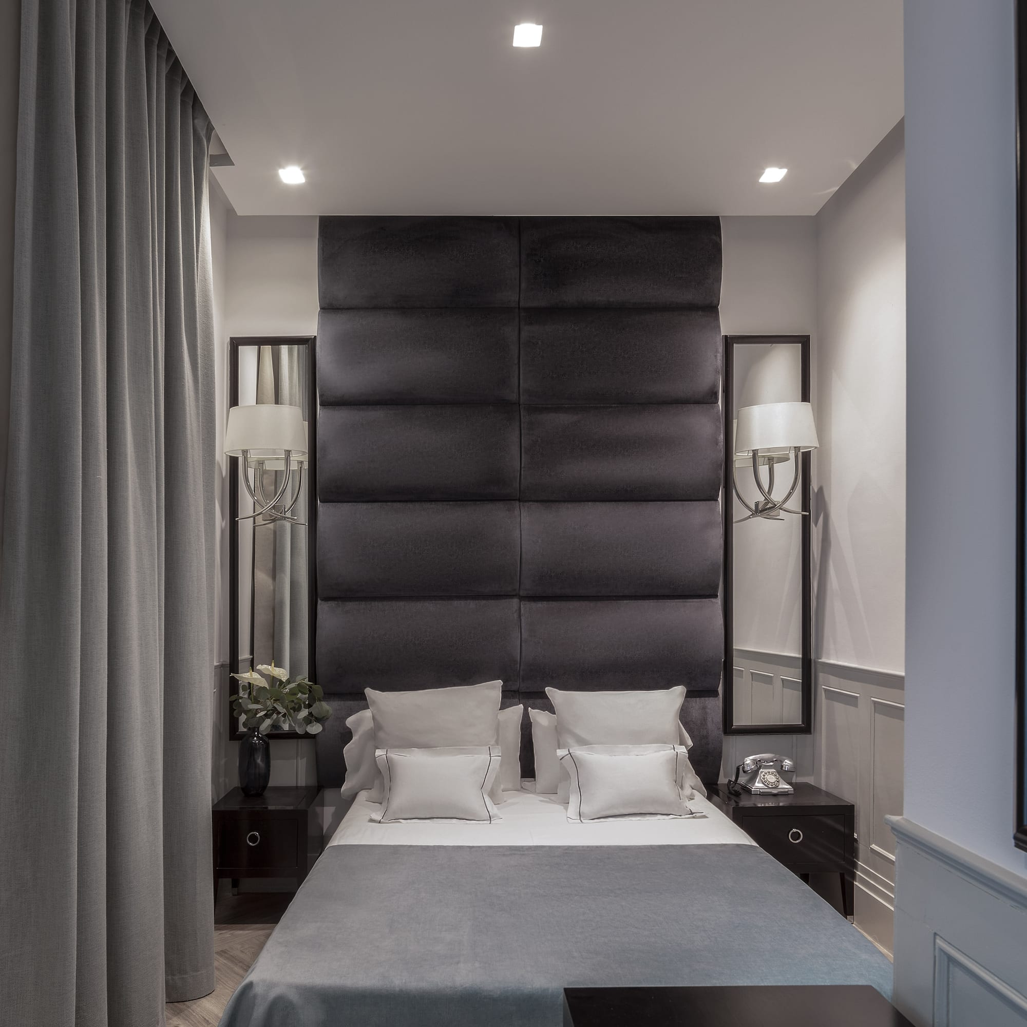 a bed with pillows and a black headboard