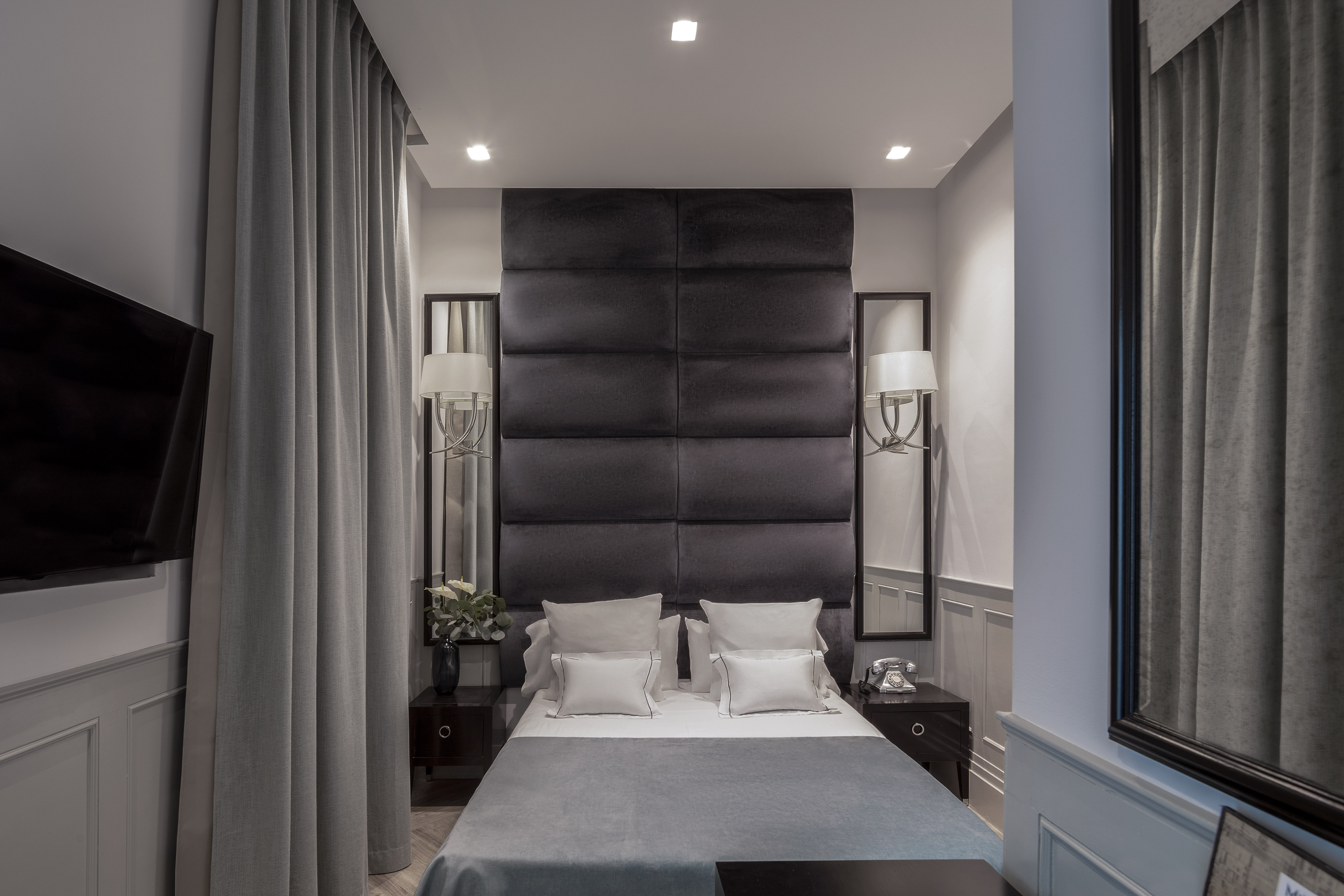 a bed with pillows and a black headboard