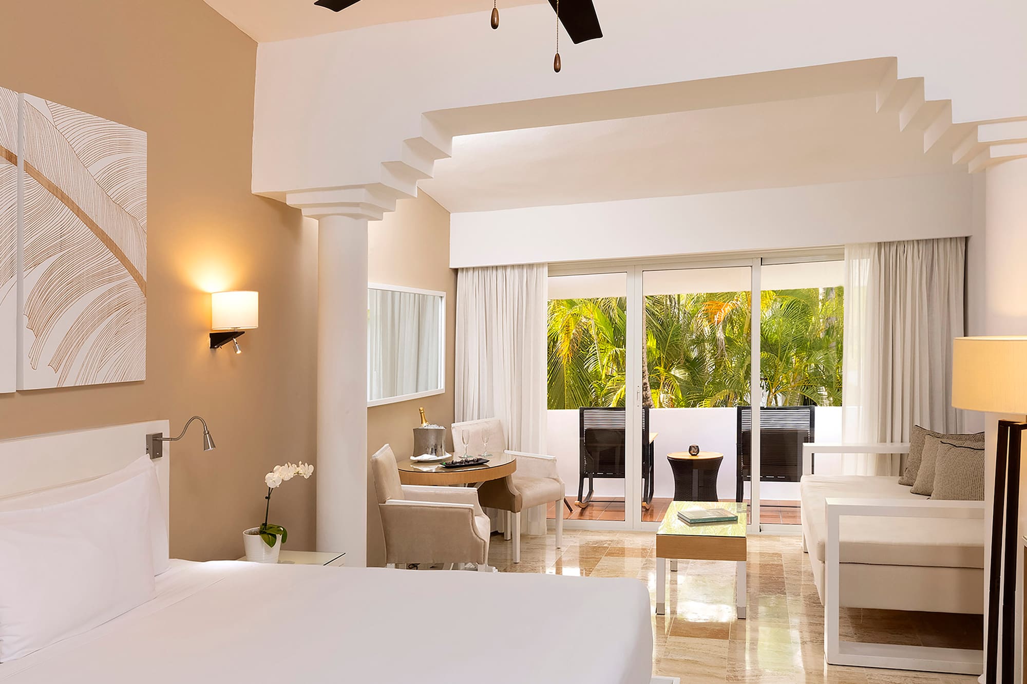 a room with a bed and a ceiling fan