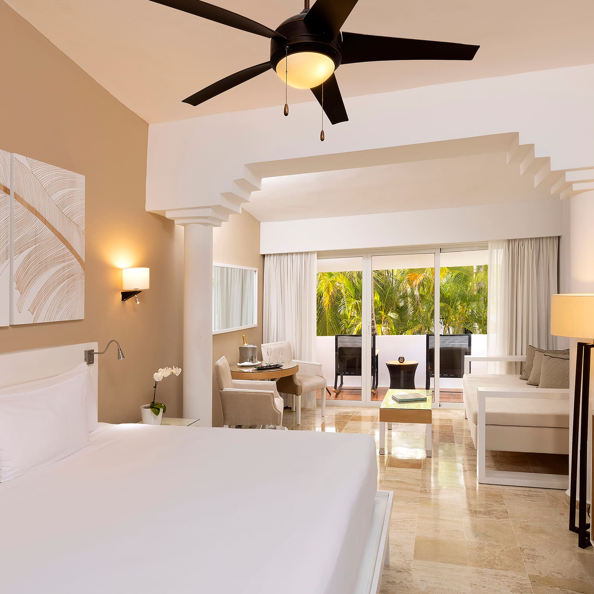 a room with a bed and a ceiling fan