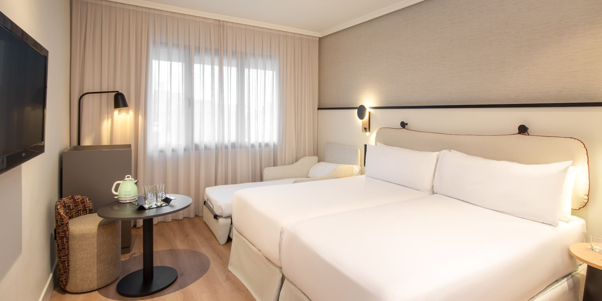 a room with two beds and a table