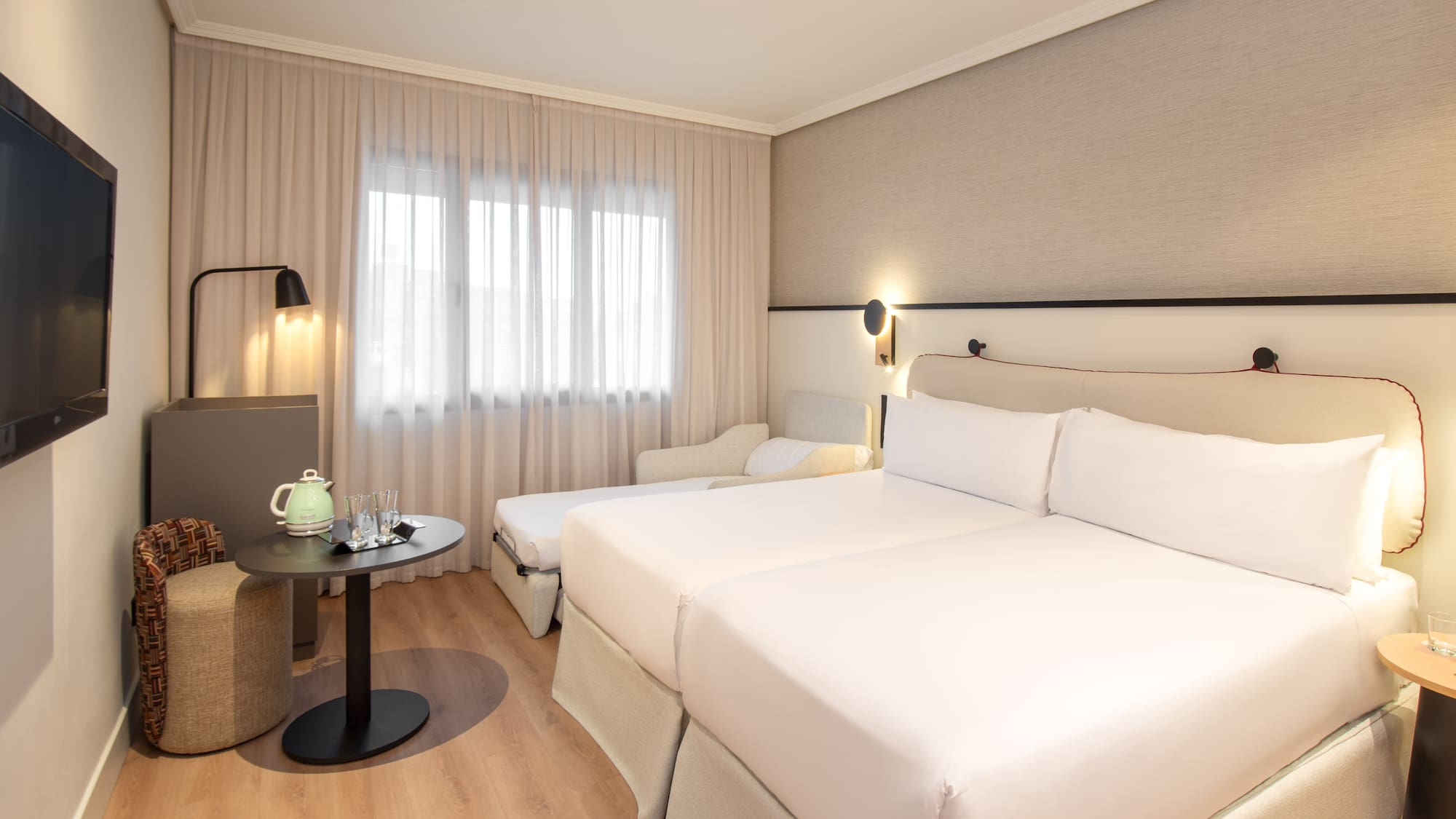 a room with two beds and a table