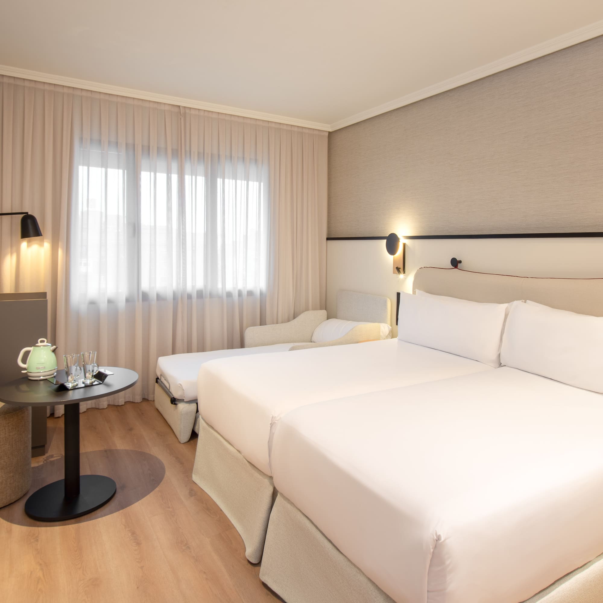 a room with two beds and a table