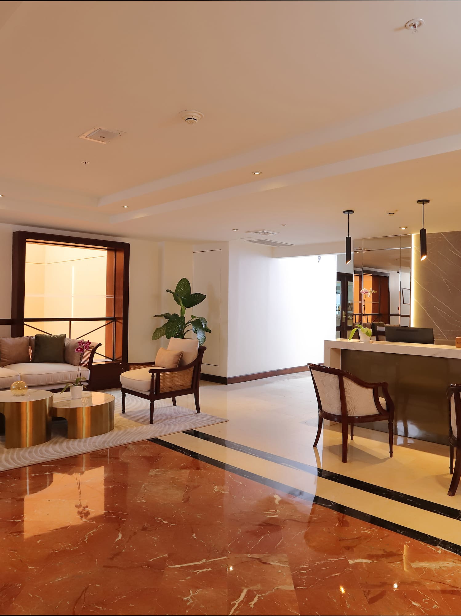 a lobby with a reception desk and chairs