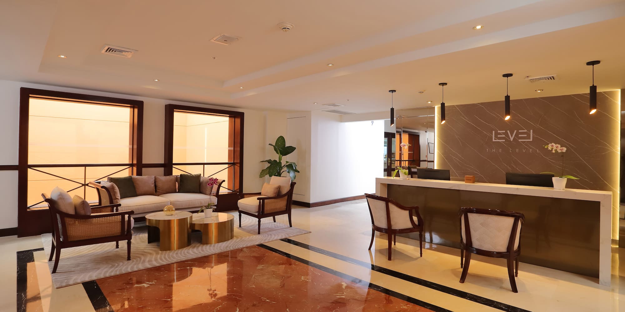 a lobby with a reception desk and chairs