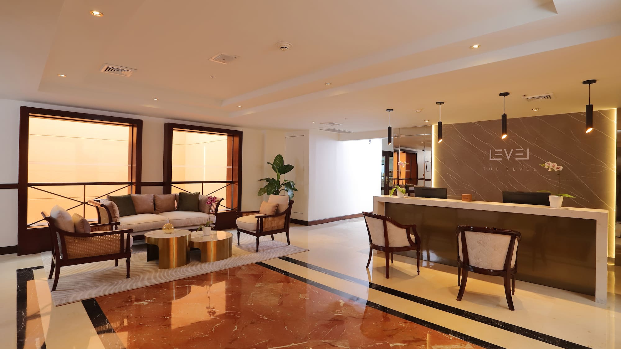 a lobby with a reception desk and chairs