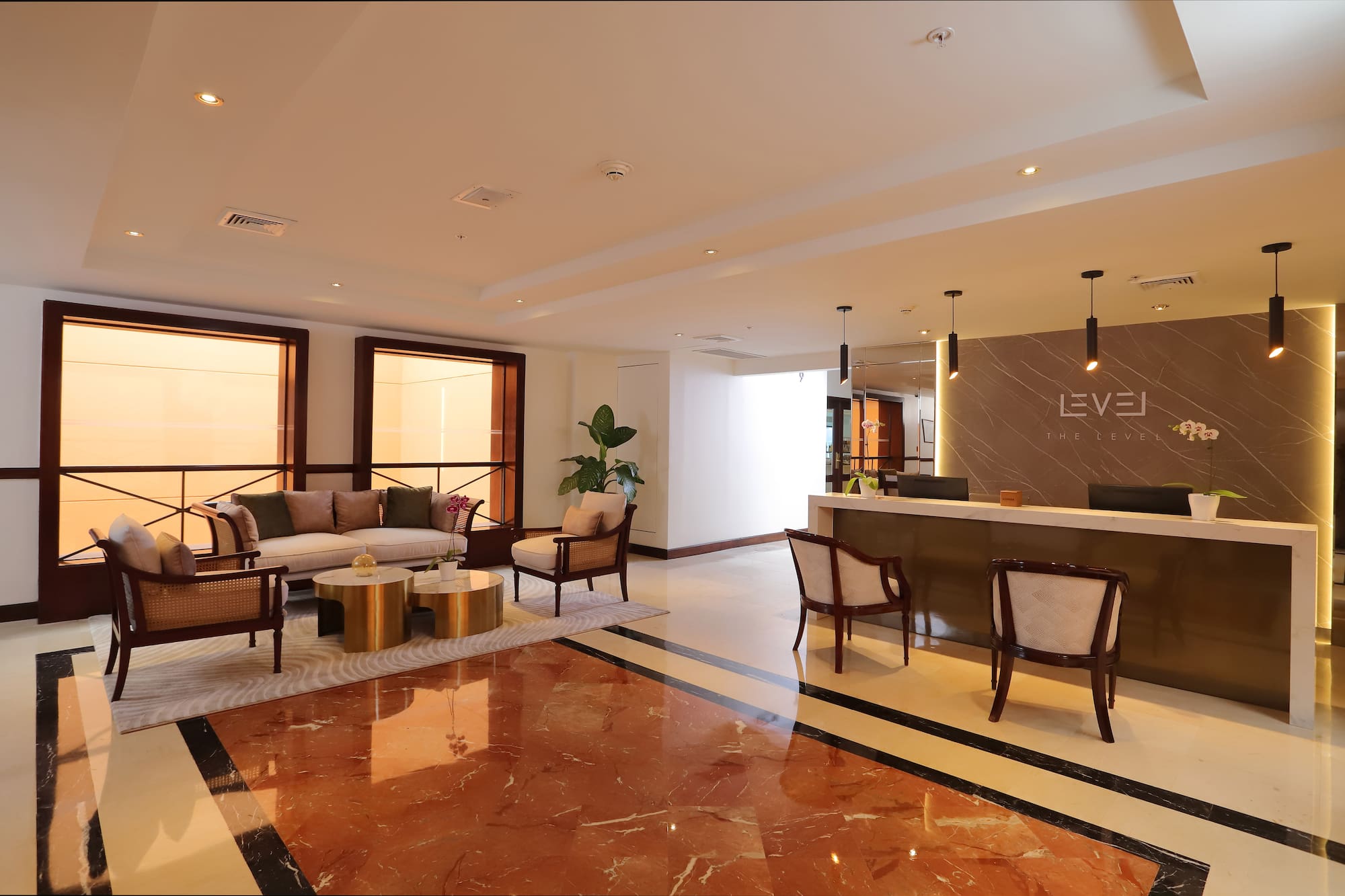 a lobby with a reception desk and chairs