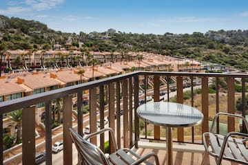 a balcony with a table and chairs and a view of a town