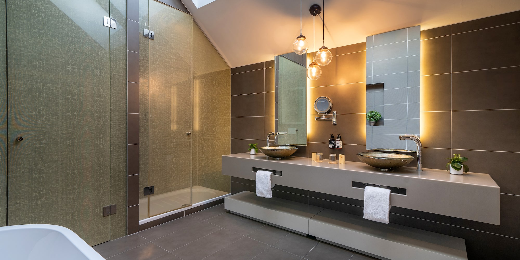 a bathroom with a shower and two sinks