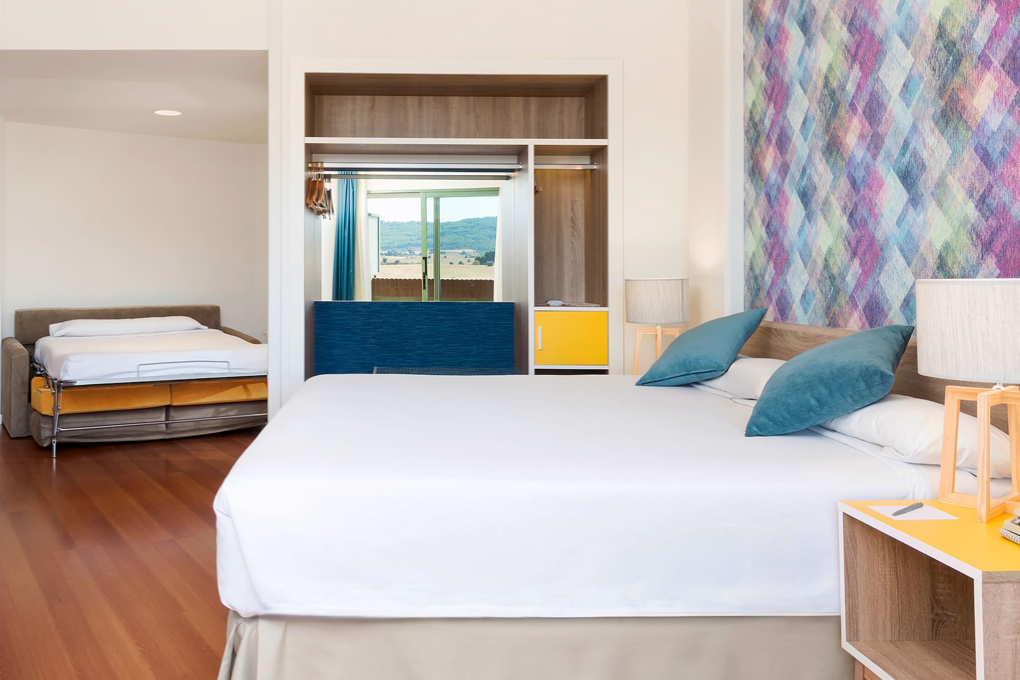 a room with a bed and two beds