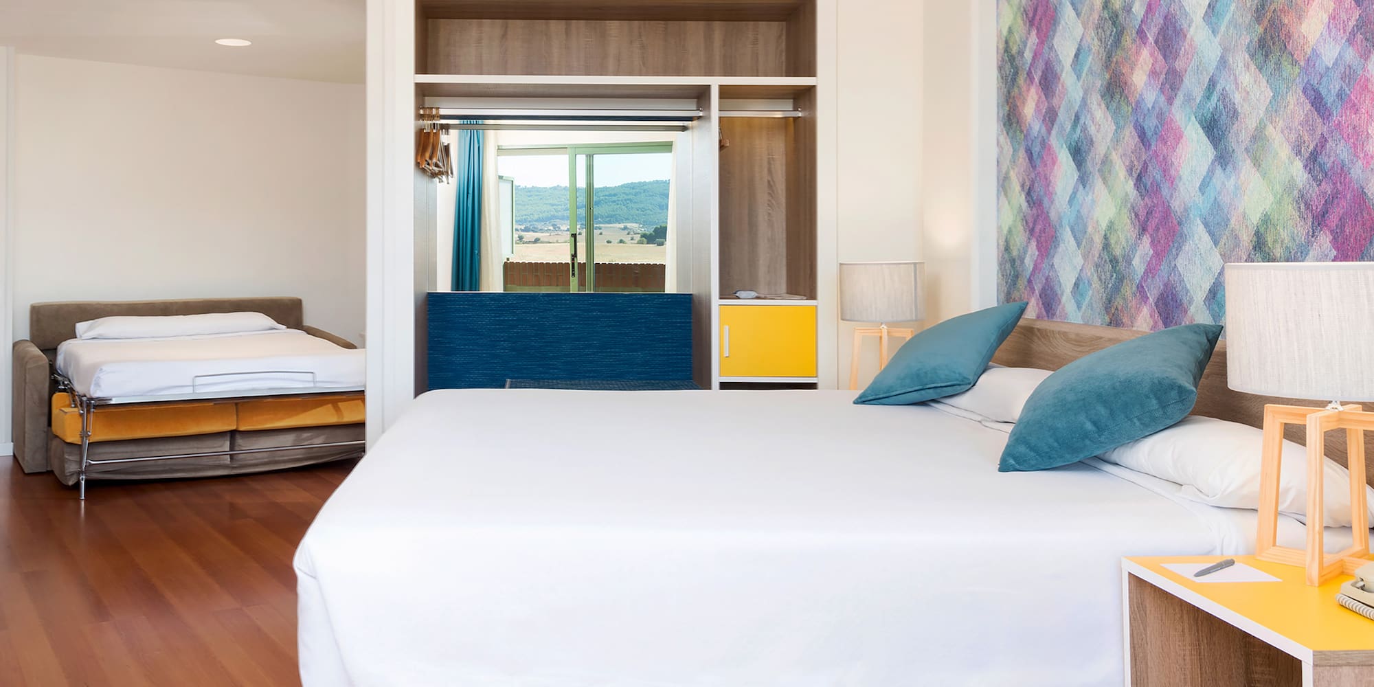 a room with a bed and two beds