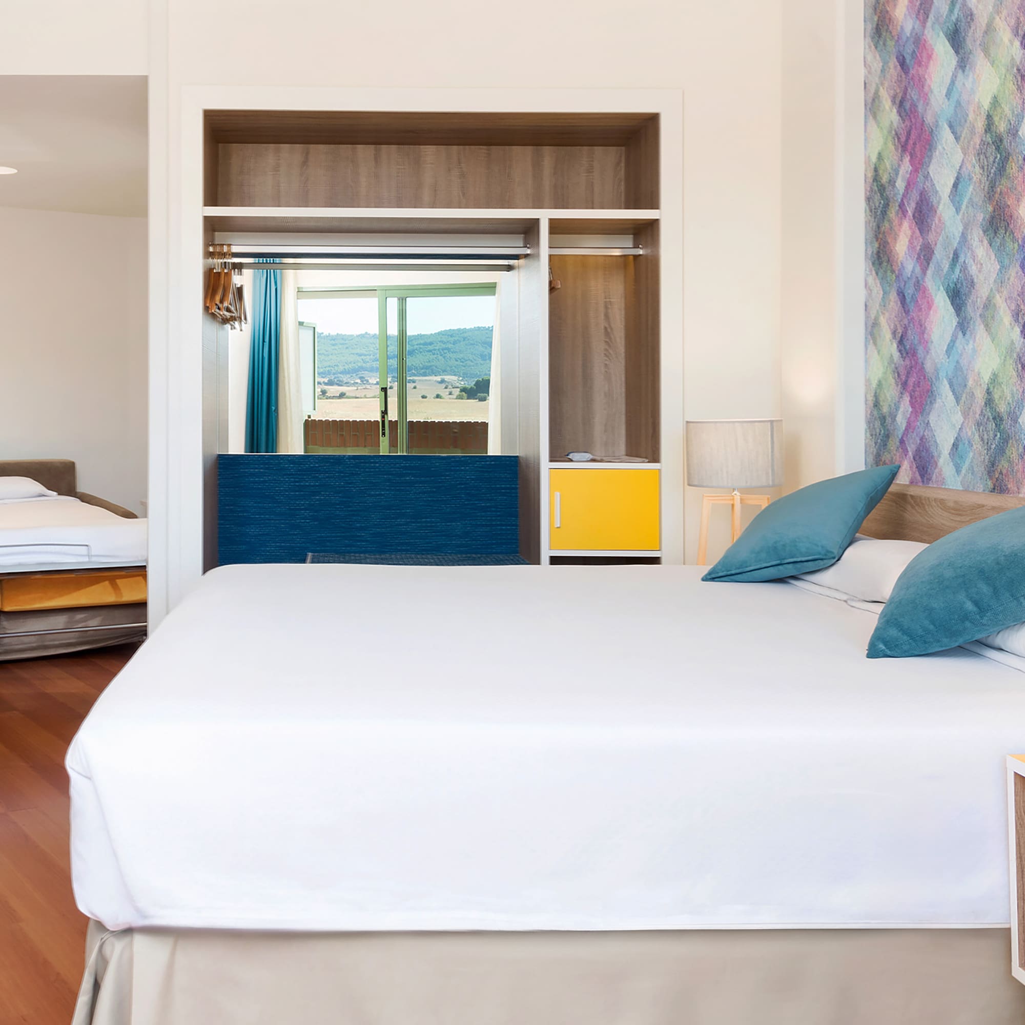 a room with a bed and two beds