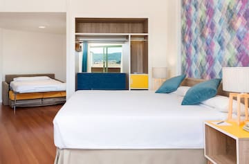 a room with a bed and two beds