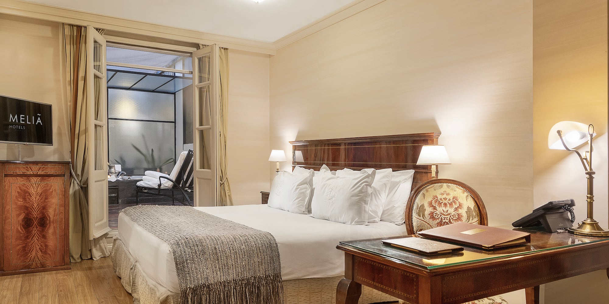 a bedroom with a desk and a bed